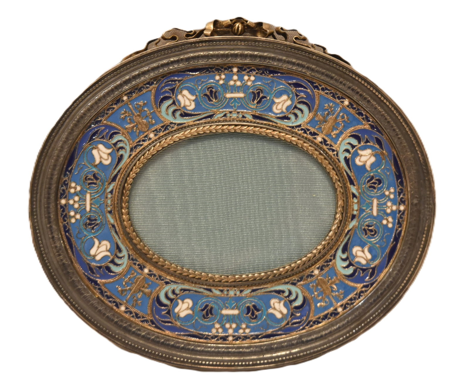 OVAL SILVER & GILT CLOISONNE ENAMEL FRAME: RUSSIAN ? OVAL SILVER & GILT CLOISONNE ENAMEL PHOTOGRAPH PICTURE FRAME WITH BOW CARTOUCHE & WOODEN BACK ; POSSIBLY RUSSIAN - PHOTO SIZE IS 3" x 2" ; OVERALL IS 6 1/2" x 5 1/2'PLEASE NOTE THIS ITEM IS 