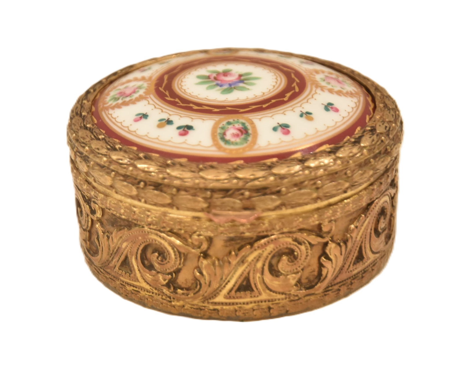 ROUND FRENCH GILT BRONZE & PORCELAIN BOX: ROUND FRENCH BRONZE BOX WITH HAND PAINTED FLORAL PORCELAIN LID - 3" x 1 1/2"PLEASE NOTE THIS ITEM IS BEING SOLD AT AN OFF SITE LOCATION & PREVIEW IS UNAVAILABLE ; AFTER SALE ARRANGEMENTS NEED TO BE MA