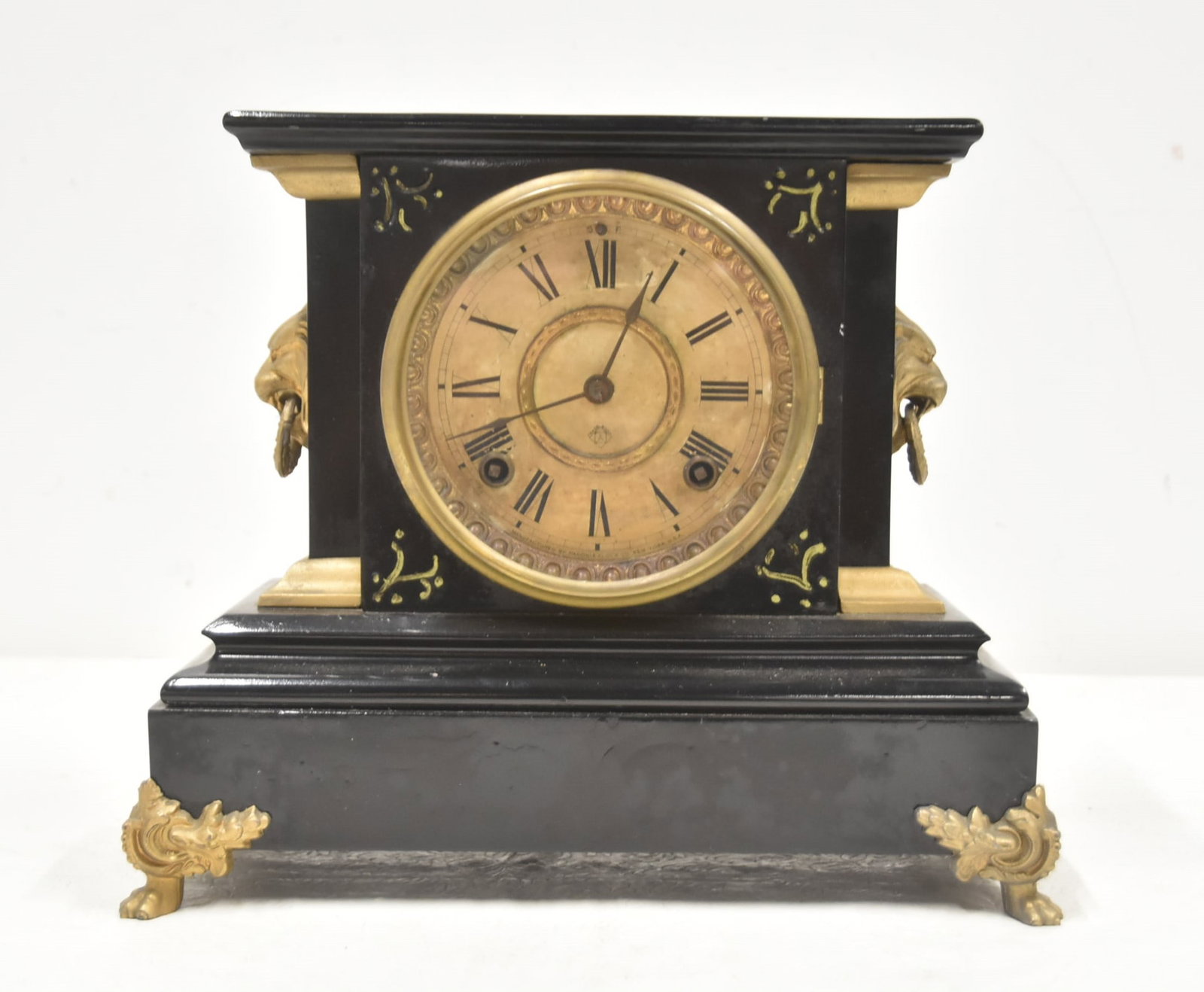 ANSONIA IRON MANTEL CLOCK: ANTIQUE ANSONIA IRON MANTEL CLOCK WITH GILT MOUNTED LION HEADS & PAW FEET - 12" x 5 1/2" x 10 1/2"