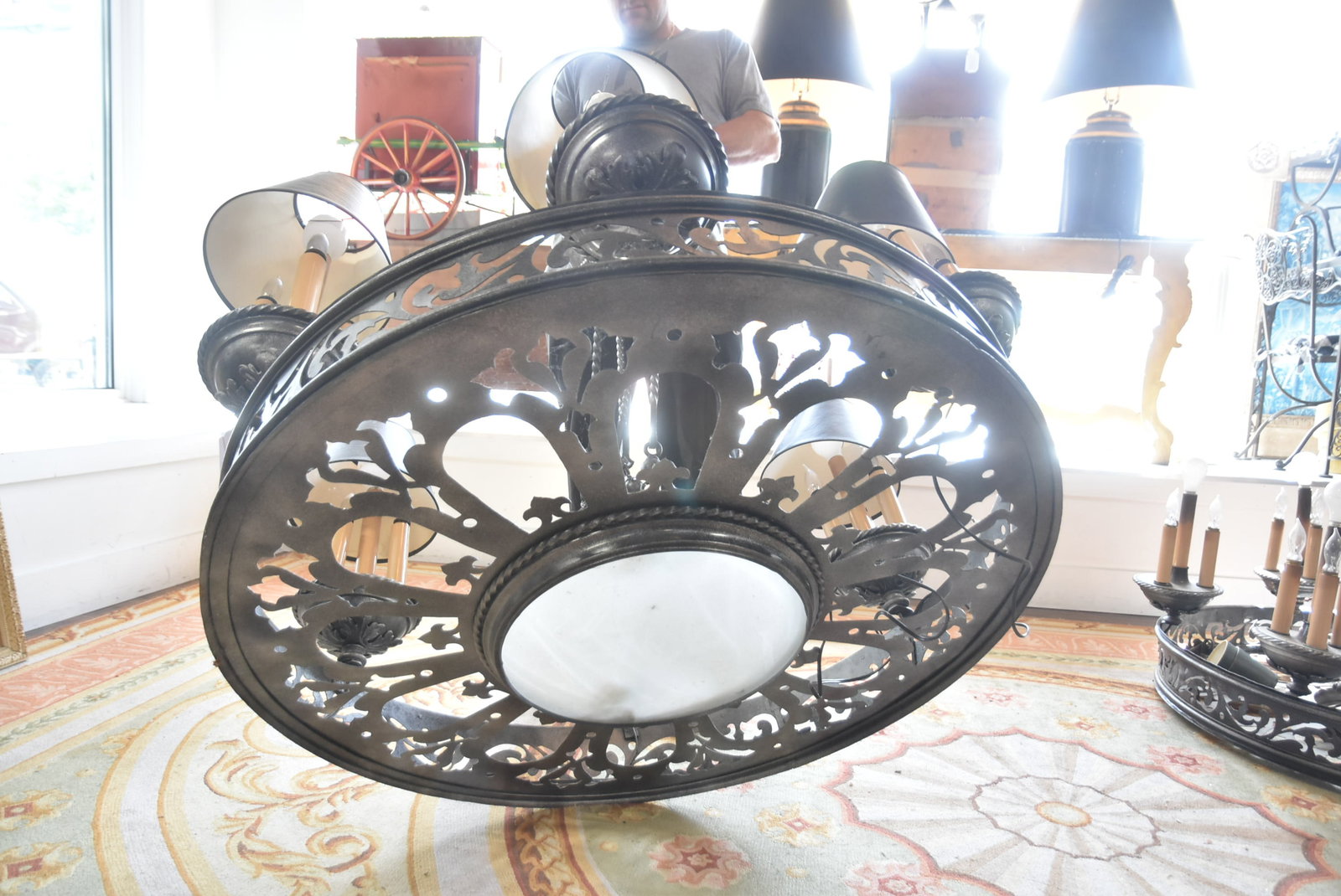 MONUMENTAL GOTHIC WAGON WHEEL CHANDELIER: MONUMENTAL GOTHIC REVIVAL STYLE IRON & MIXED METAL WAGON WHEEL CHANDELIER WITH PIERCED CUT OUTS & SCROLLED METAL WORK WITH CIRCULAR BANDS ; HAVING 6 ARMS WITH CANDELABRA FORM LIGHTS ; 24 LIGHTS TOTAL 