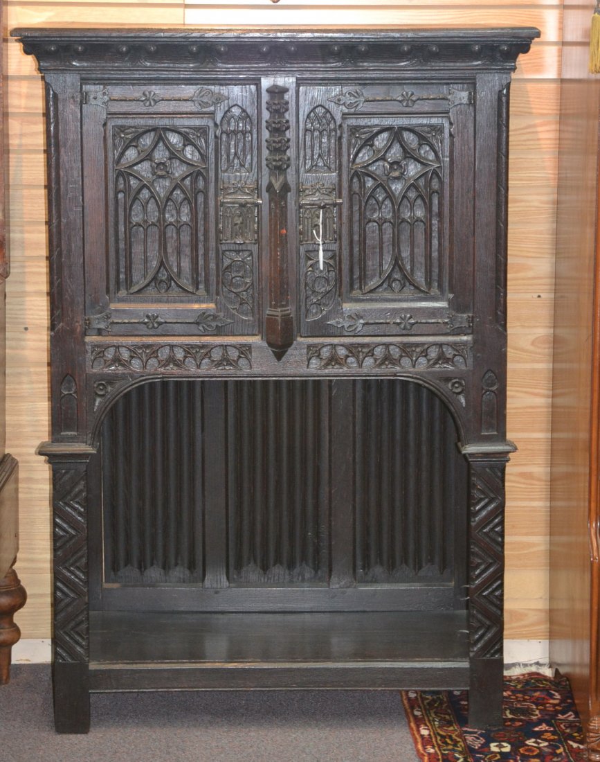 2-DOOR GOTHIC CARVED CABINET WITH FIGURAL HARDWARE: 39 1/2" x 18 1/2" x 56"