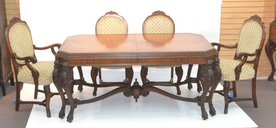 CARVED WALNUT DINING ROOM TABLE WITH (6) CHAIRS: INCLUDING (2) ARM CHAIRS & (4) 12" LEAVES - TABLE IS 44" x 70" x 31 1/2"