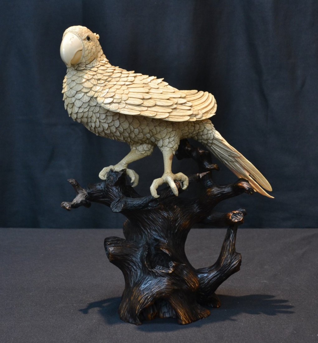 FINELY CARVED MAMMOTH IVORY PARROT PERCHED ON: CARVED WOOD TREE FORM STAND - 9" x 4" , 13 1/2"OVERALL - PLEASE NOTE THIS IS 100 % MAMMOTH IVORY OR FOSSIL IVORY AND ARE TUSKS FROM WOOLY MAMMOTH THAT ROAMED THE EARTH 10,000-40,000 YEARS AGO AND ARE