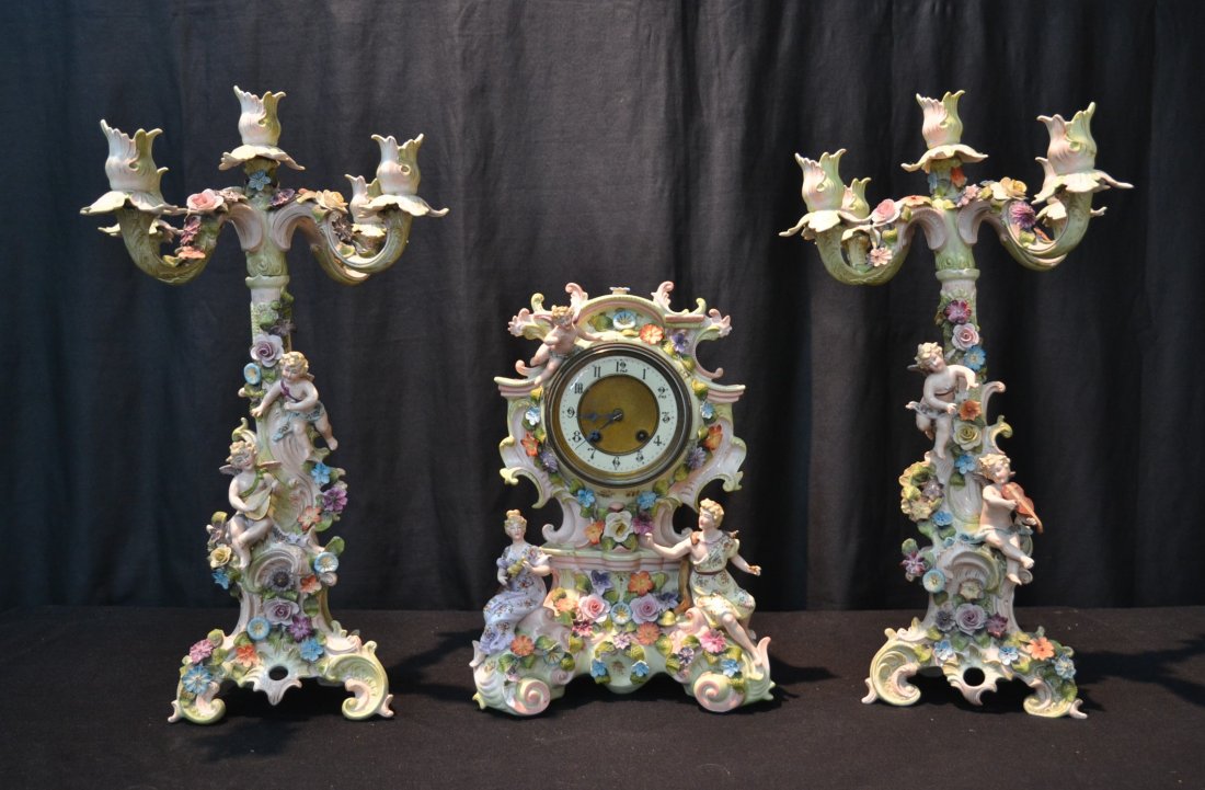 MATCHING (3)pc PORCELAIN CLOCK SET ENCRUSTED: WITH FLOWERS WITH CHERUBS PLAYING INSTRUMENTS CONSISTING CLOCK (10" x 6" x 14" )& (Pr) 2-PART CANDELABRAS (7" x 21")