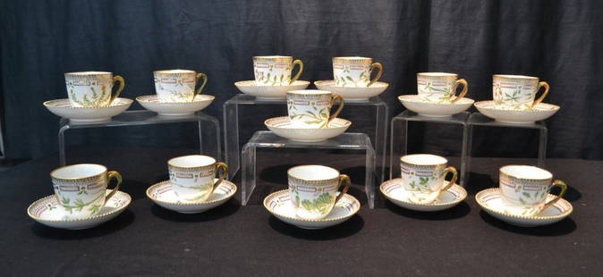 SET OF (12) FLORA DANICA CUPS & SAUCERS BY: ROYAL COPENHAGEN WITH HAND PAINTED BOTANICALS , DOUBLE TWIST HANDLES , GILT TRIM & SAW TOOTH EDGES ; (5 5/16" D ) SAUCERS 3597 , CUP IS 2 1/2" x 3 3/4" ; MATCHED SET ALL DIFFERENT