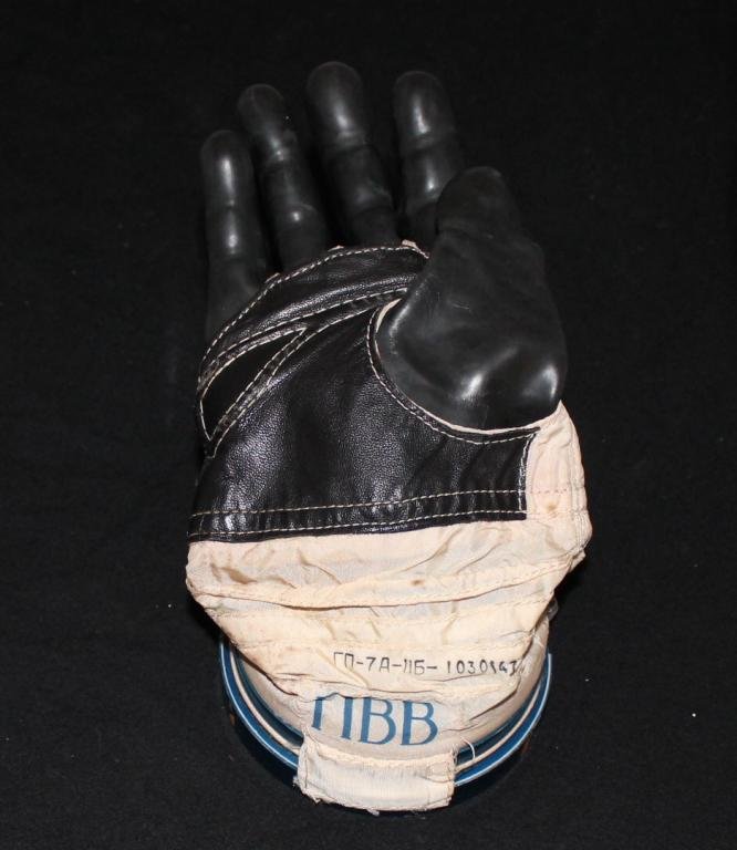 Valeri Polyakov's Flown TM-18 Spacesuit Glove: A flown spacesuit glove belonging to cosmonaut Valeri Polyakov and worn by him during his Soyuz TM-18 mission to Mir in 1994. It bears his initials in cyrillic. Complete with a Russian COA from Aleksa