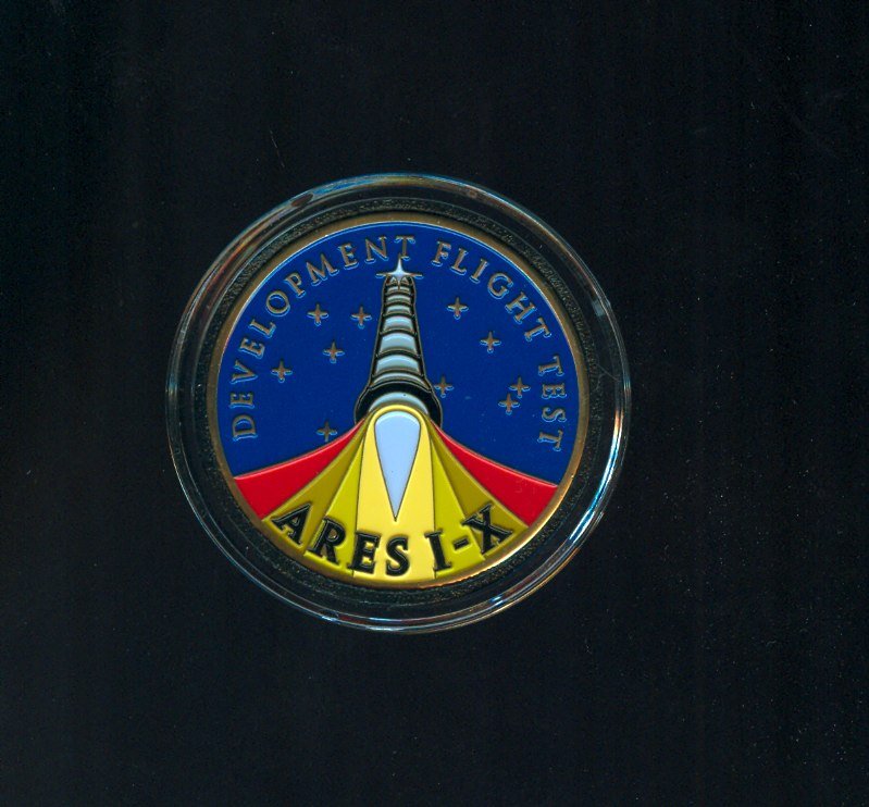 Ares 1-X Medallion With Fragment of Flown Metal: A 1.75" diameter medallion bearing a small piece of metal flown on the Ares 1-X rocket in October 2009. Not available to the public and quite hard to find. Excellent condition.