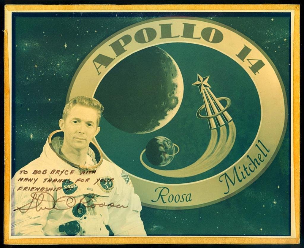 Stuart Roosa Signed NASA Color Glossy Photo: An 8"x 10" NASA color glossy photo signed by the Apollo 14 astronaut Stuart Roosa. Faded from years of being framed and displayed. Masking tape remains on the front from being taped from the front to 
