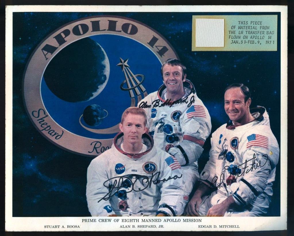 Flown Apollo 14 Lunar Transfer Bag Swatch: A flown 1" square section of the Apollo 14 LM Transfer Bag material attached to an 8"x 10" color litho of the crew (autopen signatures). Toning from being displayed, and scotch tape remains on the bac