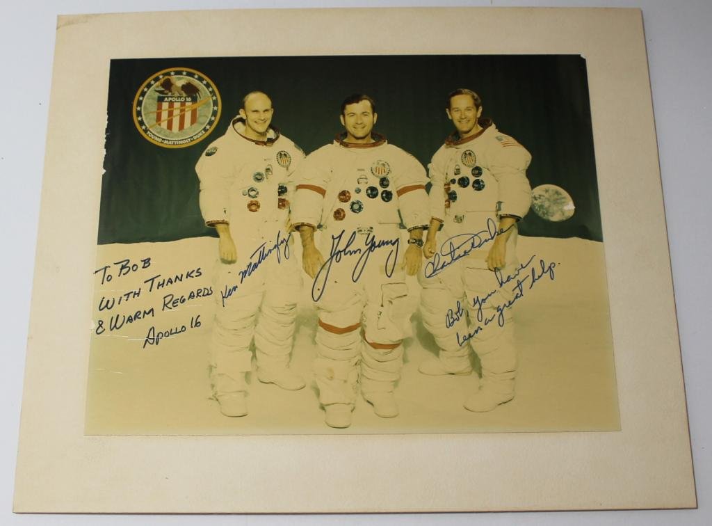 Apollo 16 Crew-Signed Matted Photo: A 7.5"x 9.5" glossy photo of the Apollo 16 crew attached to a 10"x 12" matte board, and signed by Young, Mattingly and Duke. The photo is a bit faded from being displayed for years, and there are ligh
