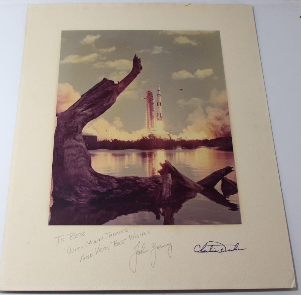 Apollo 16 Signed Matted Launch Photo: An 11"x 14" color glossy photo of the Apollo 16 launch which is attached to a 16"x 20" matte board, and presented to a friend of the astronauts. Signed on the matte by Apollo 16 crewmen Young and Duke