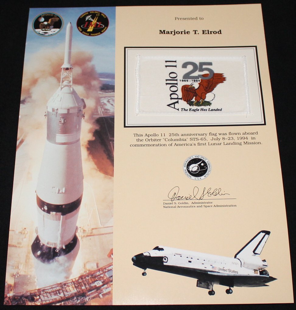 STS-65 Flown Flag: A 3"x 5" Apollo 11 25th anniversary flag flown into space aboard Columbia on STS-65 in July 1994, and it is attached to an 11"x 14" certificate. Excellent condition. Printed signature.