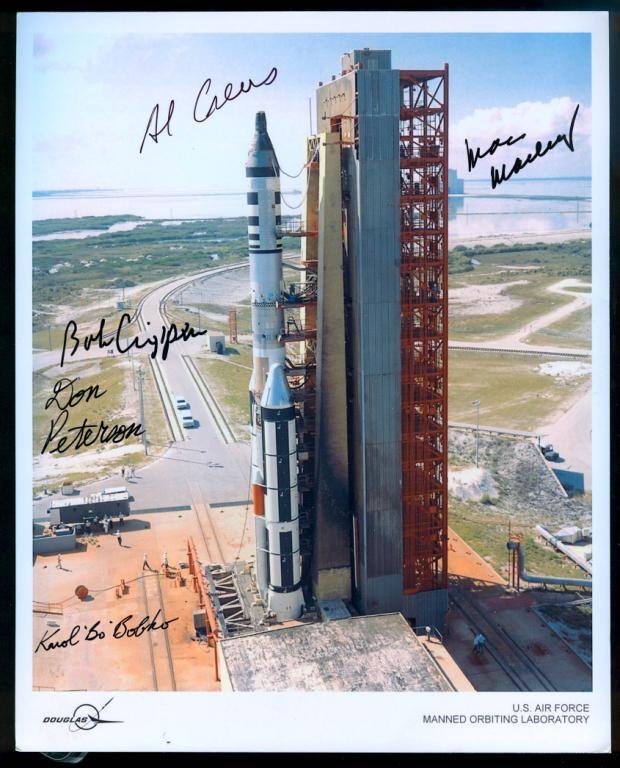 Five Astronaut Signatures on MOL Photo: An 8"x 10" photo from Douglas of the Manned Orbiting Laboratory rocket (MOL) and signed by MOL astronauts Crews, Crippen, Peterson, Bobko and Macleay. Minor lower corner flaws, but otherwise great sha