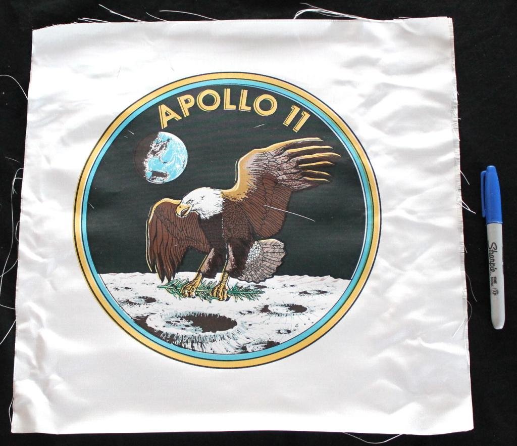 Large Apollo 11 Beta Cloth Patch: A large 14"x 14" Apollo 11 beta cloth patch bearing a 10" diameter emblem. Decent color registration with signs of handling throughout.