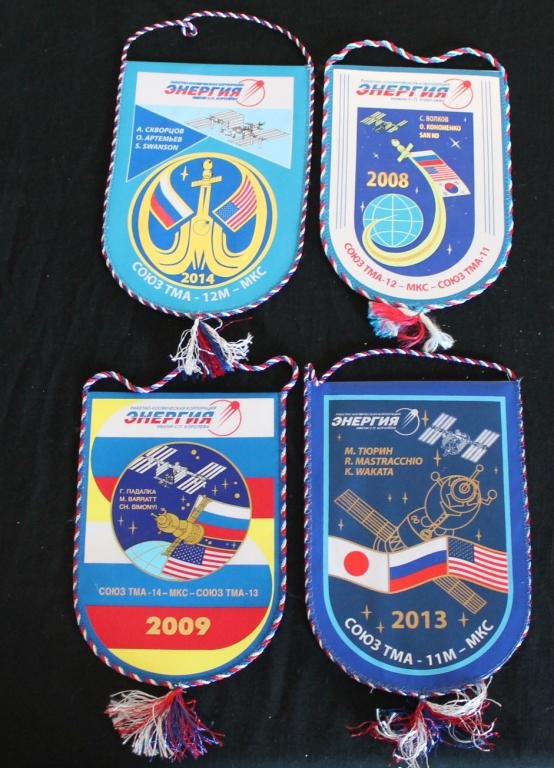 Eight Different Russian Mission Banners: Eight different 6"x 9" cloth banner from Russian banners commemorating Soyuz TMA launches and crews. All in excellent condition.