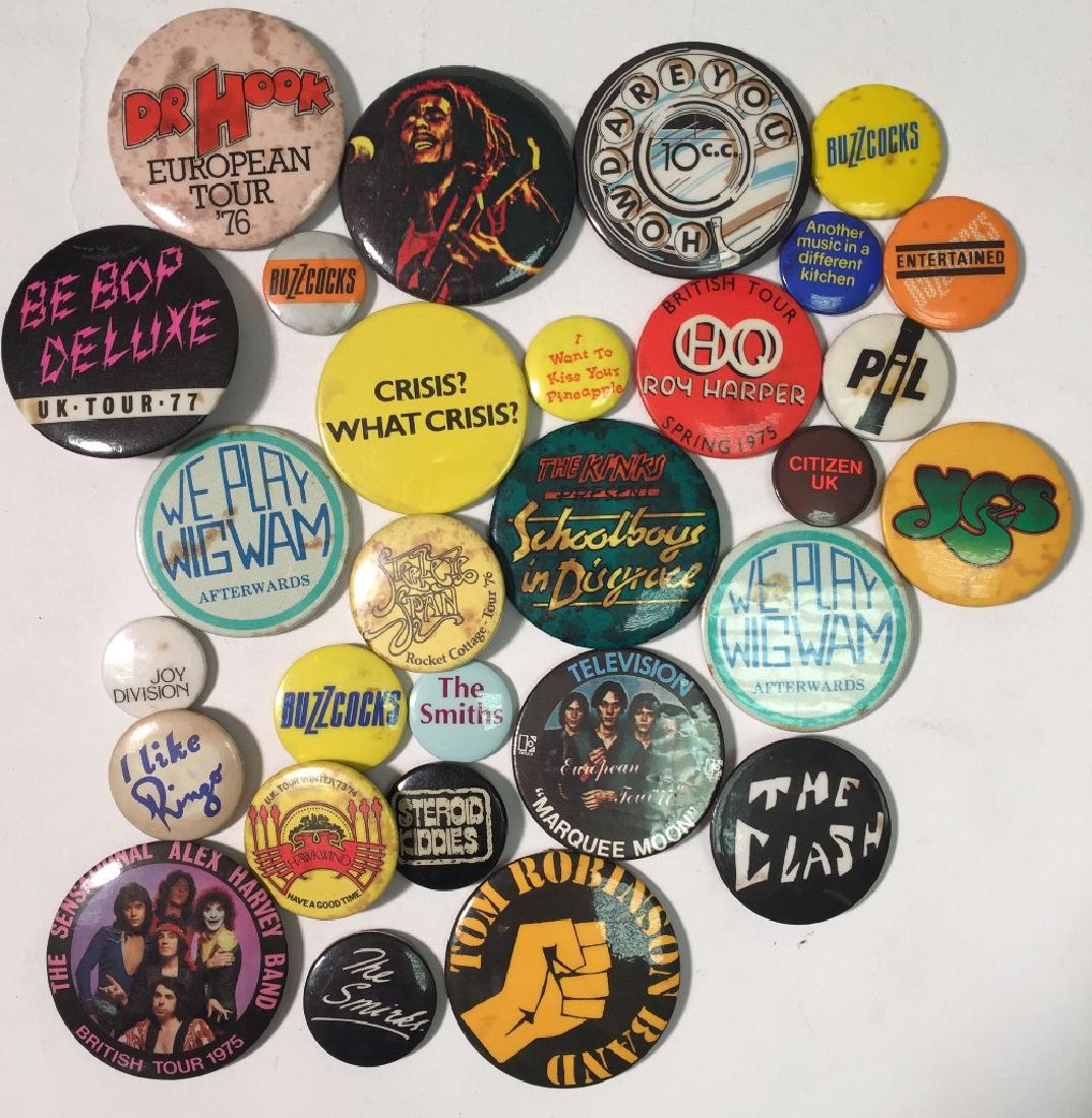 ASSORTED BADGES - CLASH/BUZZCOCKS ETC: ASSORTED BADGES - CLASH/BUZZCOCKS ETC. 29 assorted music badges, generally in good condition.