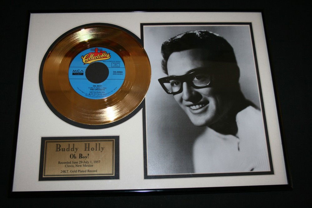 BUDDY HOLLY: BUDDY HOLLY - Framed 24kt gold disc for Buddy Holly's 'Oh Boy!' in 1957. 7" gold disc presented with 20 x 26cm b&w photo of Buddy, all mounted inside a simple 32 x 42cm black metal frame. Comes comple