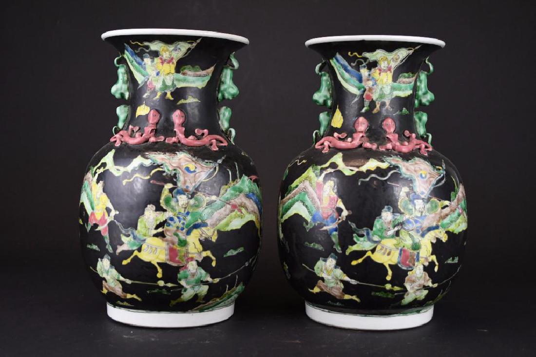 Pair of Chinese Famille Noire Porcelain Vases: Pair of Chinese Famille Noire Porcelain Vases: Depicting a Warriors on horseback in a mountain setting with six character mark to base., H: 13 Inches