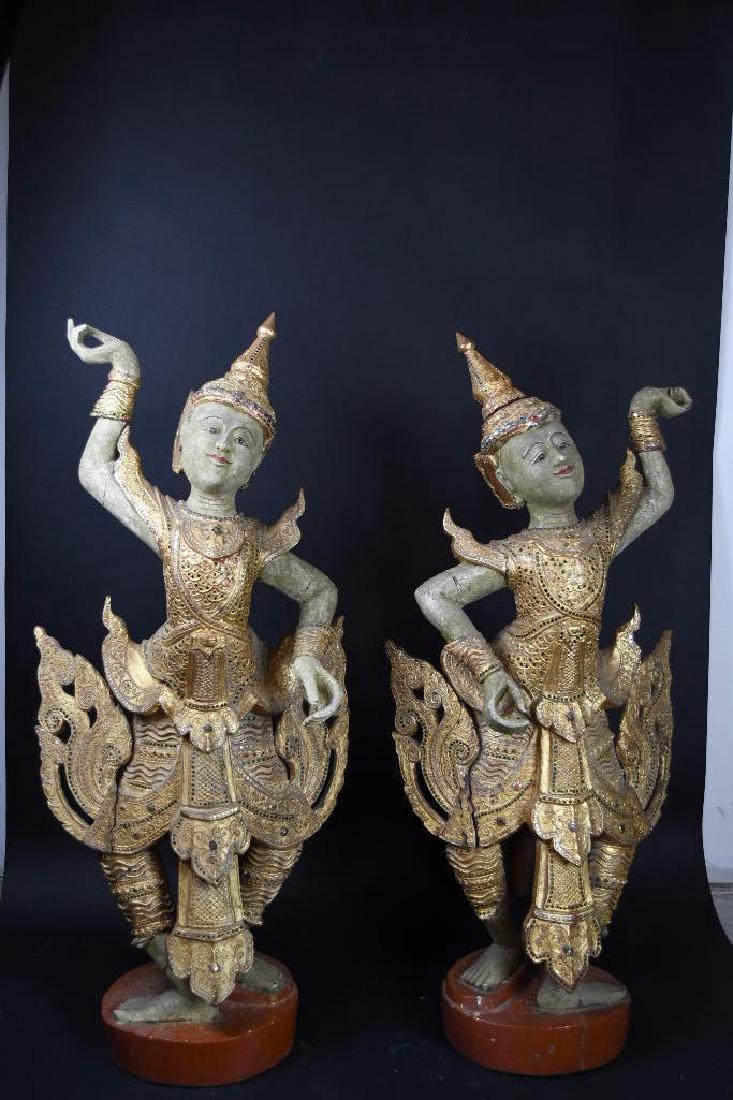 Pair of Thai Poly Chrome Carved Wood Standing Buddhas: Pair of Thai Poly Chrome Carved Wood Standing Buddhas in a dancing Pose, H: 44 Inches