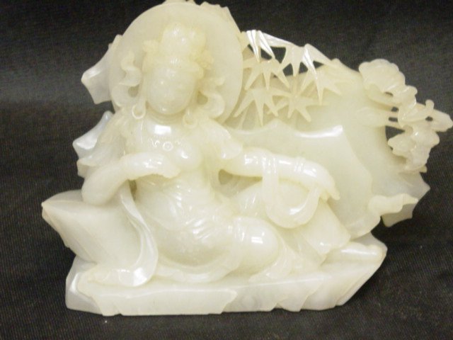 A Superb Imperial White Jade Carving of Guanyin: A Superb Imperial White Jade masterfully Carved depicting a Reclining Guan Yin - A Beautifully Carved White Jade of even color through out, in the form of a Reclining Guan Yin amongst Bamboo Trees. Me