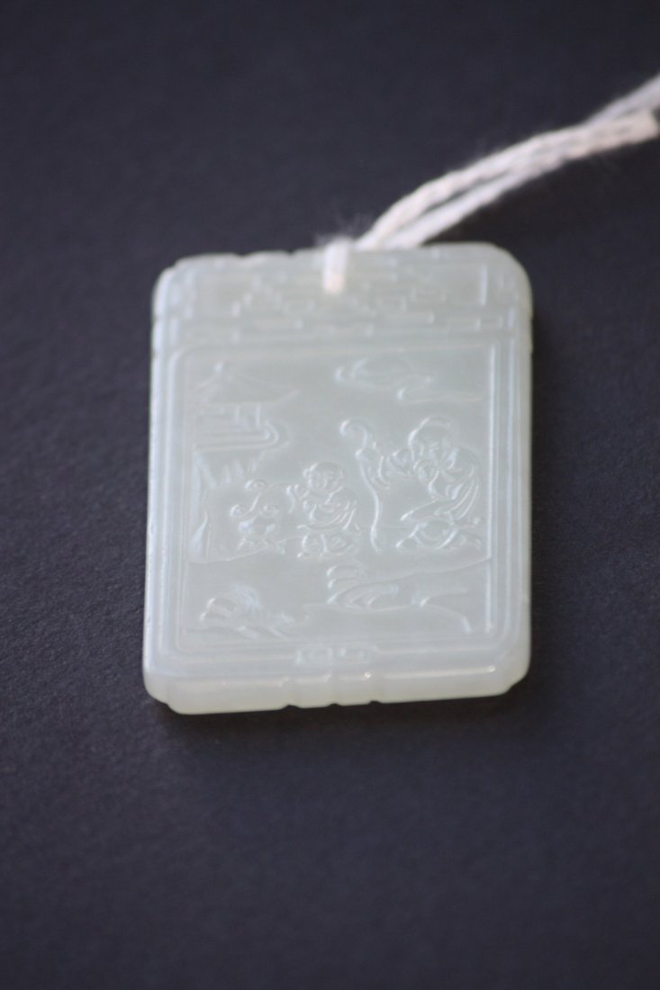 Chinese Carved White Jade Pendant Lohan and Boy: Chinese Carved White Jade Pendant Lohan and Boy carved in great relief depicting a Lohan Carrying Ruyi Scepter and a Boy. Length 2 inches.