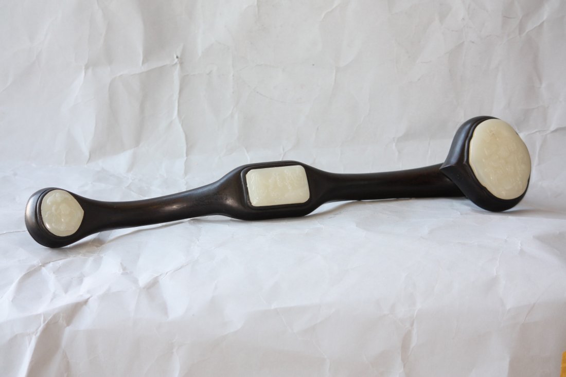 Chinese Carved Zitan and White Jade Ruyi Scepter: Chinese Carved Zitan and White Jade Ruyi Scepter. Strong and Beautiful Chinese Carved Dark Wood with inset White Jade carved in relief. Measures 19 inches Long