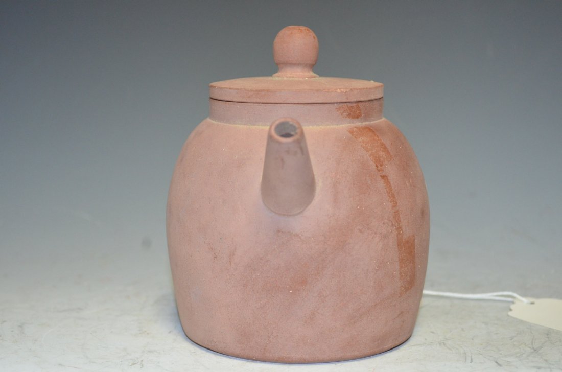 Antique Chinese Red Clay Tea Pot 15th. Century: Antique Chinese Red Clay Tea Pot with Lid of Red Clay and potted elegantly and of simple flat bottom form with Chinese Inscriptions to the Base. 15th. Century Ming Dynasty. H: 5 1/4 Inches.