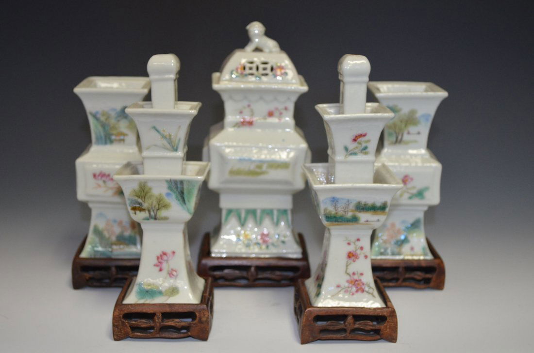 Small Chinese Porcelain Five Piece garniture set: Small Chinese Porcelain Five Piece garniture set: with a central lidded vase & four various vases all on wood bases and enamel painted with flowers & mountain landscape. (Largest) H: 7 Inches