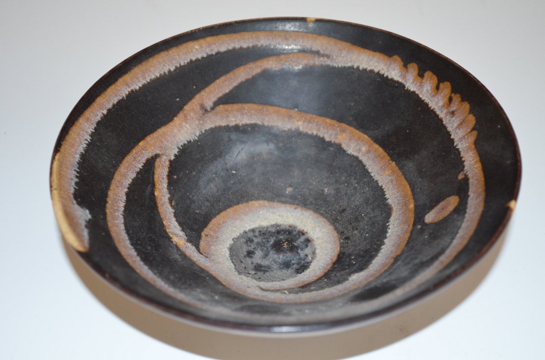 Brown Glazed Porcelain Chinese Footed Bowl: Brown Glazed Porcelain Chinese Footed Bowl with Bands of Swirling Ring on the interior and exterior. D: 6 1/4 Inches