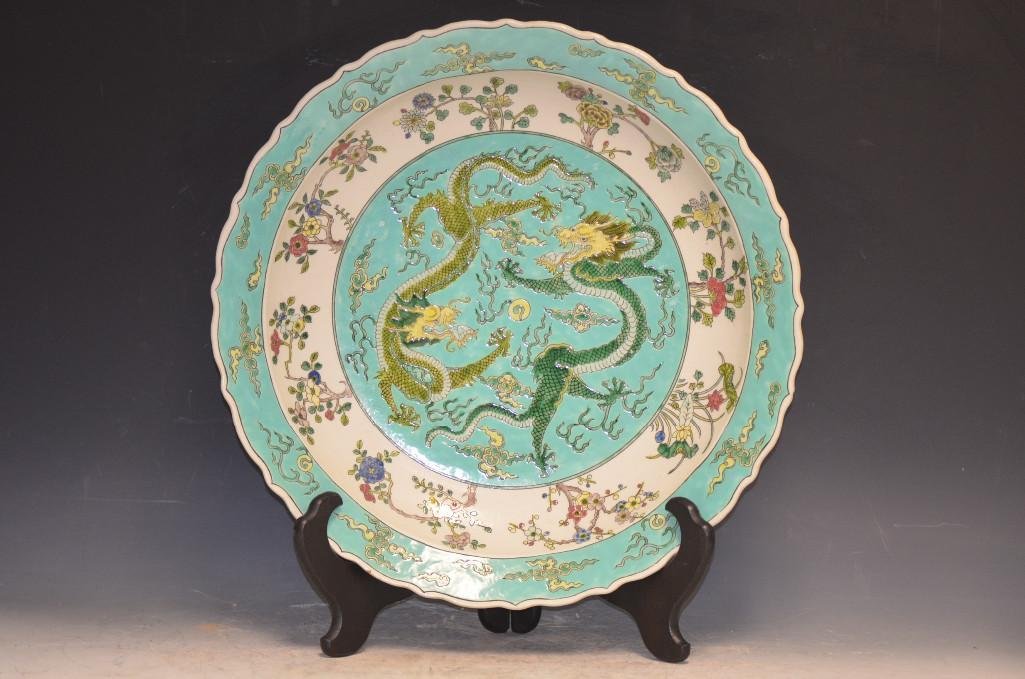 Chinese Pale Green Ground Porcelain Dragon Charger: Chinese Pale Green Ground Porcelain dragon Charger. Enamel Painting Depicts Two Dragons Chasing A Flaming Pearl Amongst Clouds, Barbed Ring & Underglaze Six Character Qian Long Reign Mark; D; 17.5 Inc