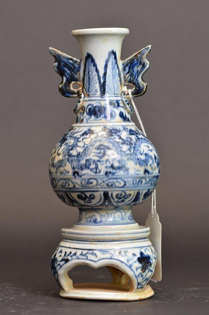 Antique Chinese Blue and White Porcelain vase with: Antique Chinese Blue and White Porcelain vase with Tripod Base painted with dragons and a delicate pattern with wing shaped handles; H: 10.25 Inches