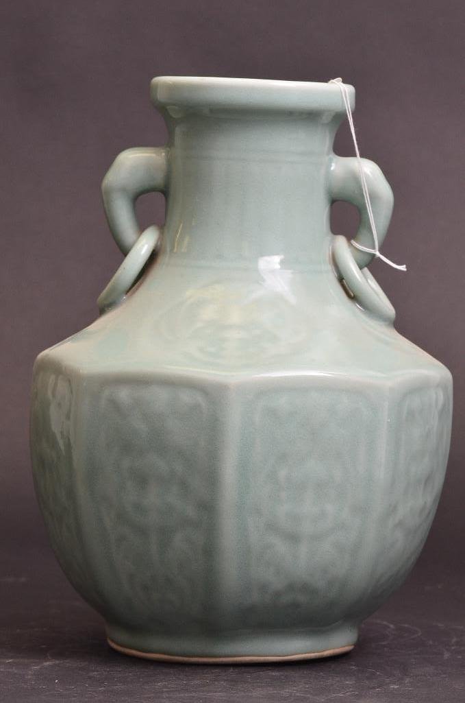 Antique Chinese Celadon Glaze Octagonal Body Vase: Antique Chinese Celadon Glaze Octagonal Body Porcelain Vase incised with patterned masques surropunding and imitation fluting on the neck and with handles; H: 11.75 Inches