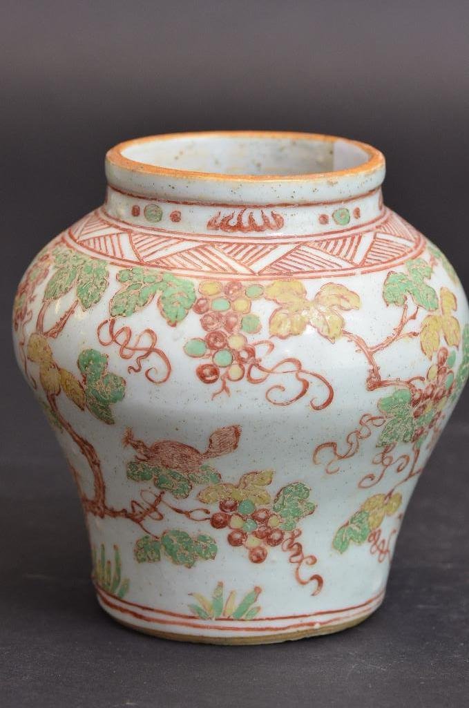 Antique Chinese White Glaze Earthenware Vase: Antique Chinese White Glaze Earthenware Vase with Iron Red, Green, and Yellow painting of grape vines and animals; H: 5 Inches