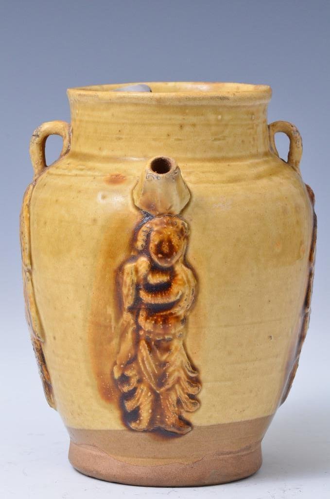 Antique Chinese Earthenware Straw and Brown Glaze Jug: Antique Chinese Earthenware Straw and Brown Glaze Jug with one true handle and two decorative handles, a spout, and designs in low relief; H: 6.75 Inches