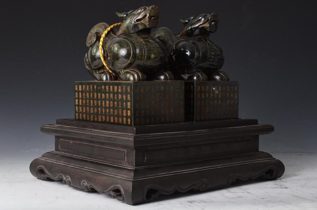 Pair of Jade Chiling Seals in Carved Wood Box: Chinese Pair of Jade Chiling Seals in a Carved Wood Box. Carved with Chinese Calligraphy on the Chilings and the Dark Wooden Box; H: 10.5 Inches for the box, L: 5.5 Inches for each Chiling