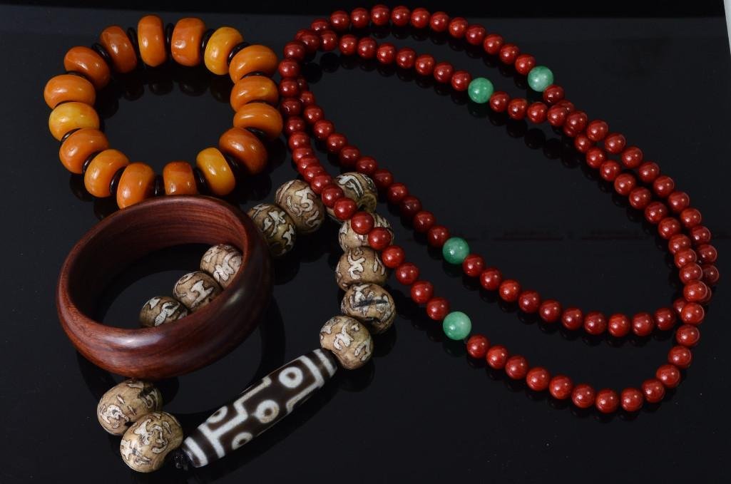Four Chinese Jewelry Items: Four Chinese Jewelry Items; One red beaded necklace, Two beaded bracelets, and one hardwood bangle; OD of the bangle: 3 inches