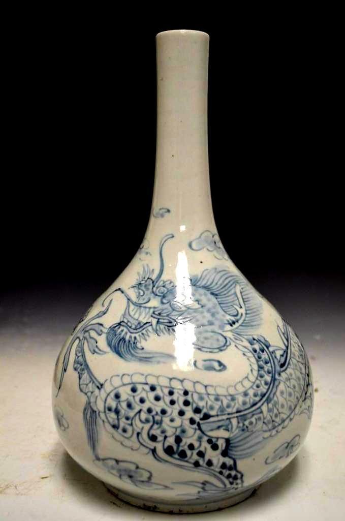 Korean Blue & White Elongated Dragon Bottle Vase: Antique Korean Blue & White Elongated Dragon Bottle Vase Depicting a Scene of Dragons Amongst The Clouds; H: 12.75 Inches