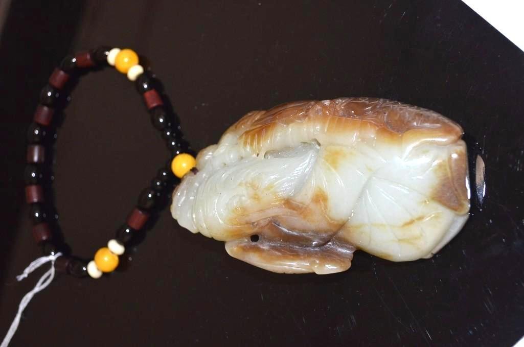 Carved Jadeite Lohan on a Beaded String: Carved Jadeite Figure of a Lohan on a Beaded String. Carved with a protector boy and a fish; L: 4.75 Inches