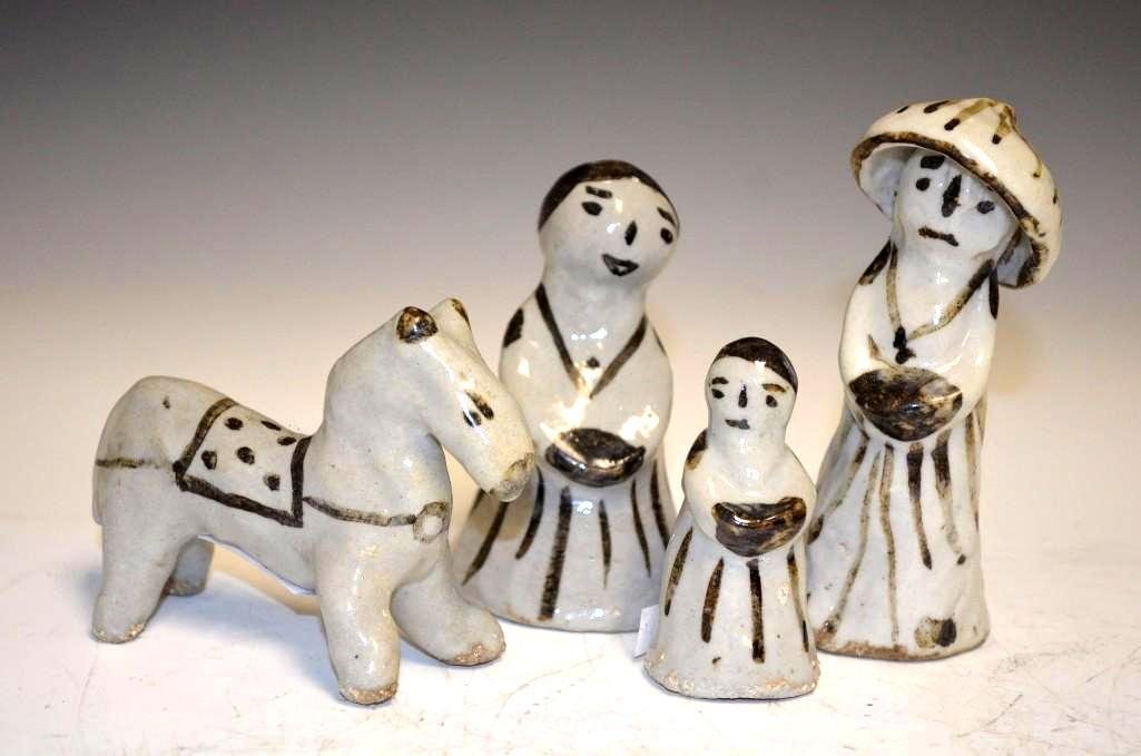 Four Korean Iron Oxide brown & White Porcelain: Four Antique Korean Iron brown and White Porcelain Figures of a Man, Woman, Child and Horse. Family group is loosely molded and painted with facial features and clothing. The adult male figure wears a
