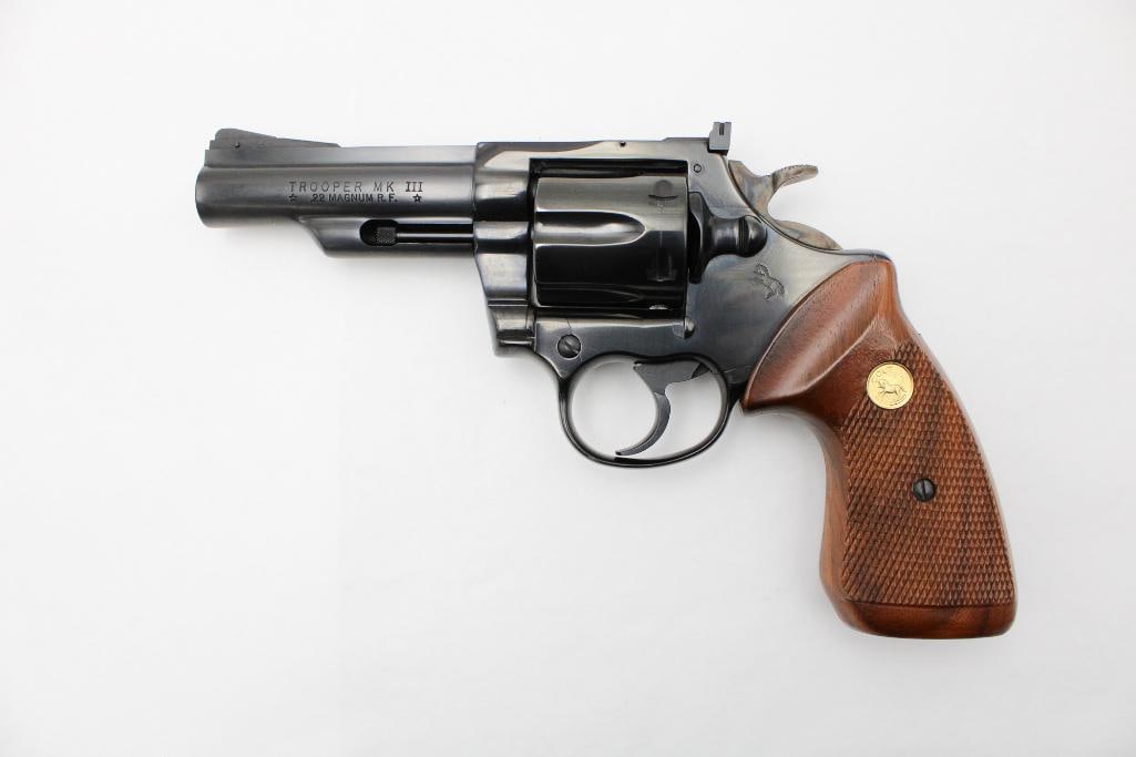 Colt Trooper MK III Double Action Revolver: s.n. Y12756, .22 Magnum, 4" barrel, retaining near 100% blue, checkered walnut grips with gold Colt medallion, with the factory box. Modern (25-0174)