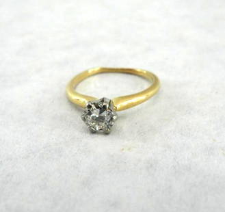 18K Yellow Gold, Platinum and Diamond Solitaire Ring: Fiery 6mm/.75 carat +/- round diamond in a six prong platinum setting on a simple 18K yellow gold band. Size 6.5. Approx. 1.4 grams total weight.
