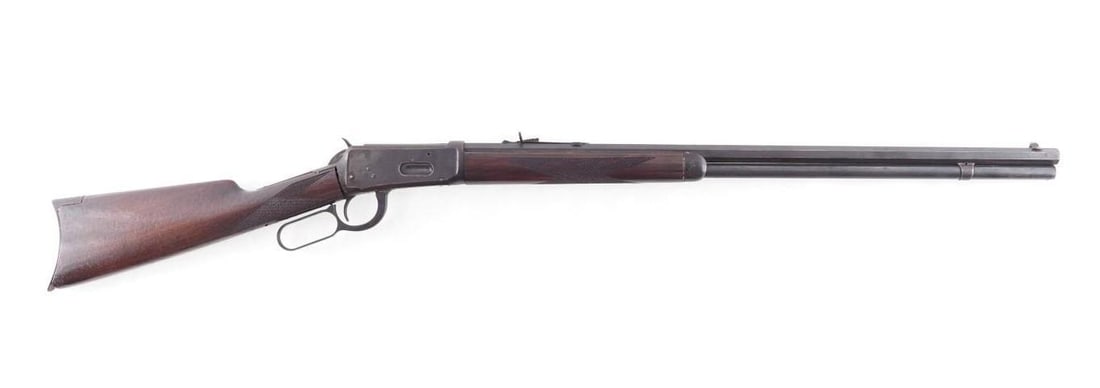 Winchester Model 1894 Lever Action Rifle: s.n. 229751, .32-40, 26" octagon barrel, full magazine, crescent butt plate. The finish plum / gray throughout with small areas of oxidization and the wood replaced, mechanically good. Mfg. ca. 1904.