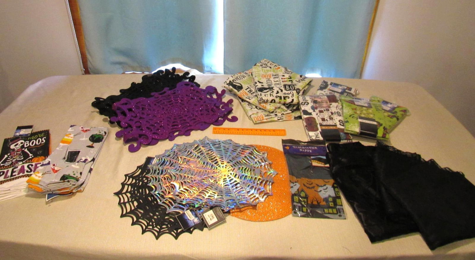 Asst. Tablecloths & Towels: (2) packs of hand towels, (2) table runners, (6) placemats, (1) plastic tablecloth, (3) black table cloths, (3) plastic table cloths, (4) plastic tablecloths new in package, 21 pieces total
