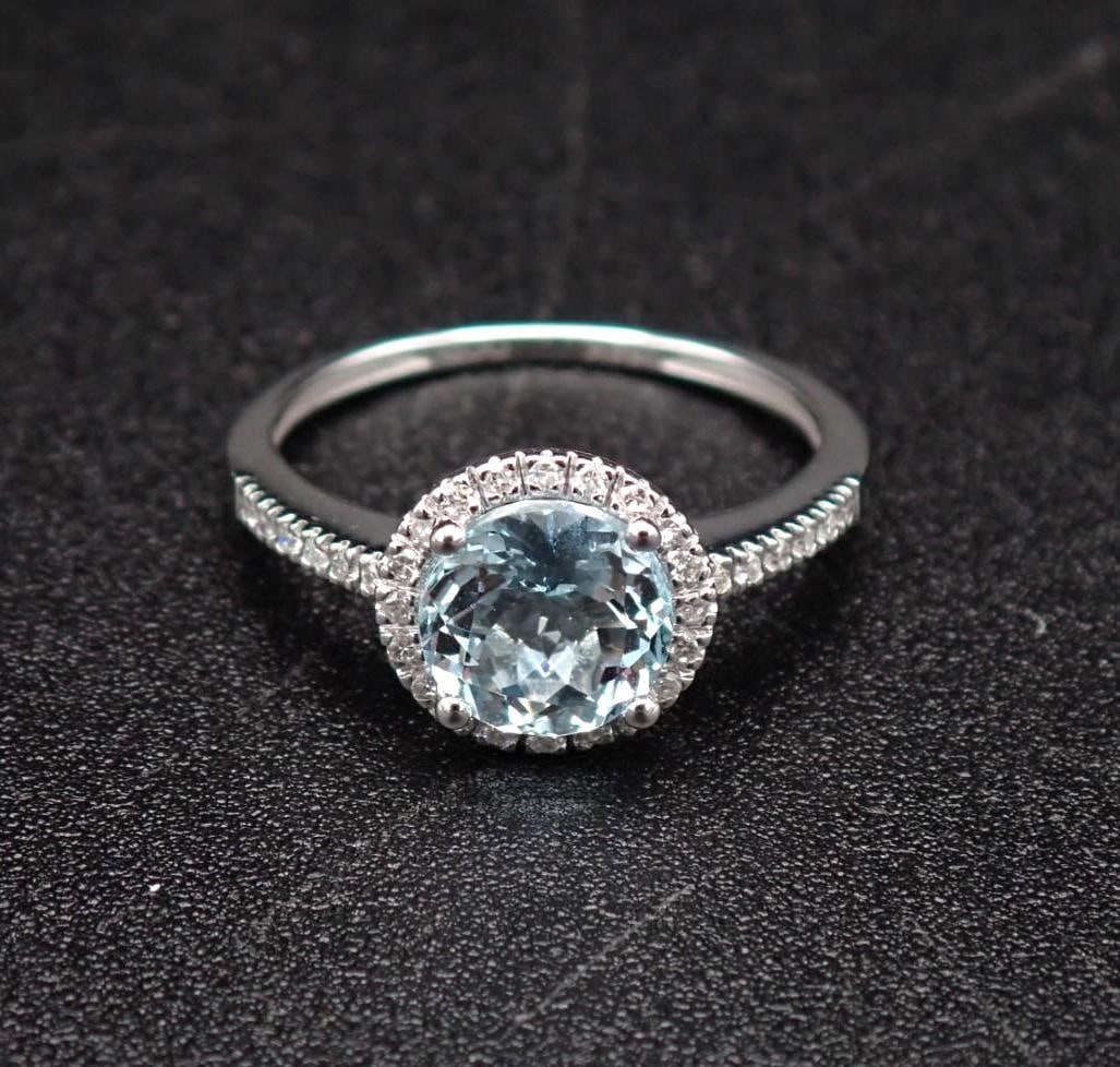 14K White Gold and Aquamarine Ring: 7mm round cut aquamarine with (32) 1mm +/- white sapphires surrounding and on the shoulders, size 6, 1.89 grams total weight