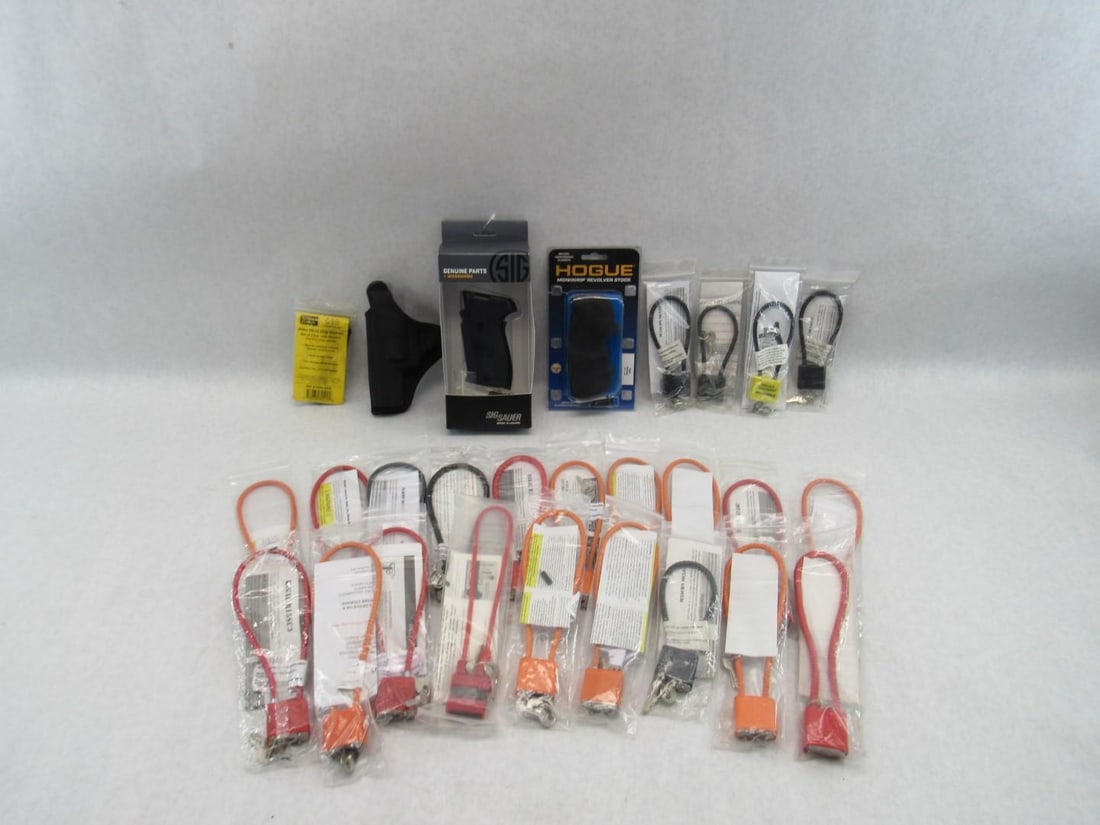 Gun Show Lot: (22) gun locks; Hogue grips for Ruger Redhawk; Sig Sauer 220 grips; Kimber grips; Bianchi left hand small revolver holster 