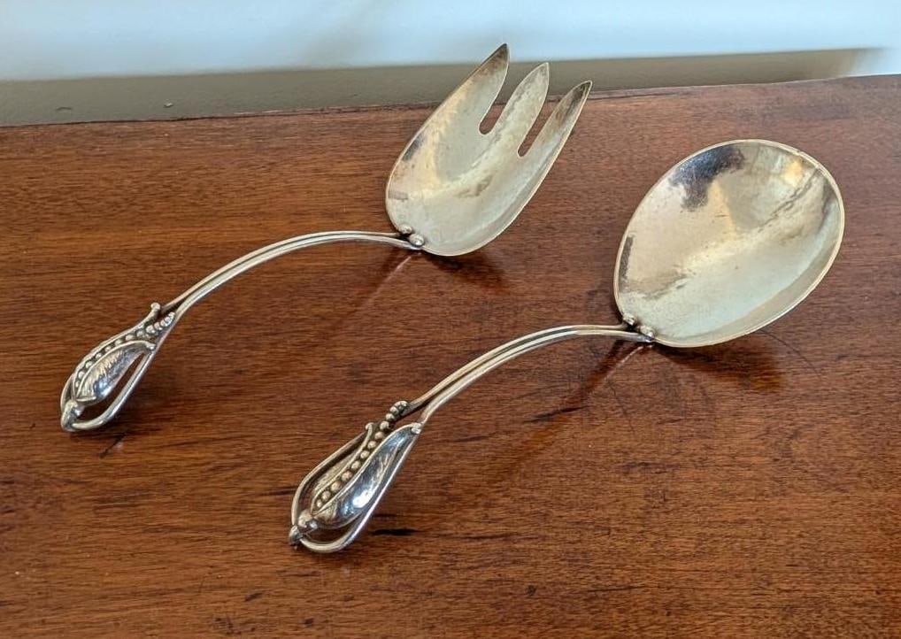 Carl Poul Petersen, Montreal, Hand Wrought Sterling Silver Salad Serving Set: blossom pattern in the style of Georg Jensen; 8.25" in length; 154.7 grams 