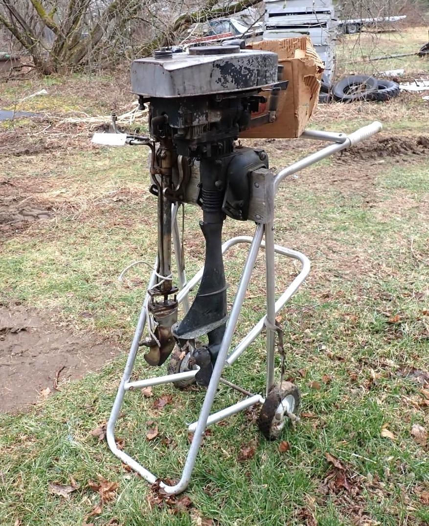 (2) Vintage Outboard Motors: incl. Johnson m/n: 100 & Sears Roba m/n: 217-58560, includes aluminum stand **as found**, Location: Backyard 