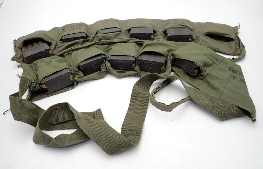 (56+/-) .30 Cal. Cartridges, (24+/-) .30 Cal Brass, (2) Bandoliers: (56+/-) .30 Cal. Cartridges, (24+/-) .30 Cal Brass, (2) Bandoliers