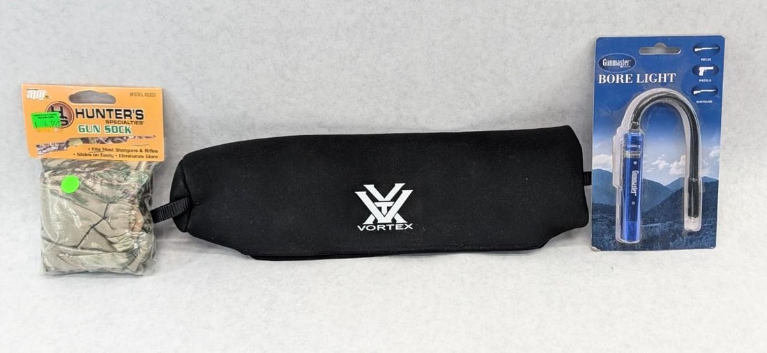 Assorted Gun Accessories: Includes bore light, gun sock, and scope cover