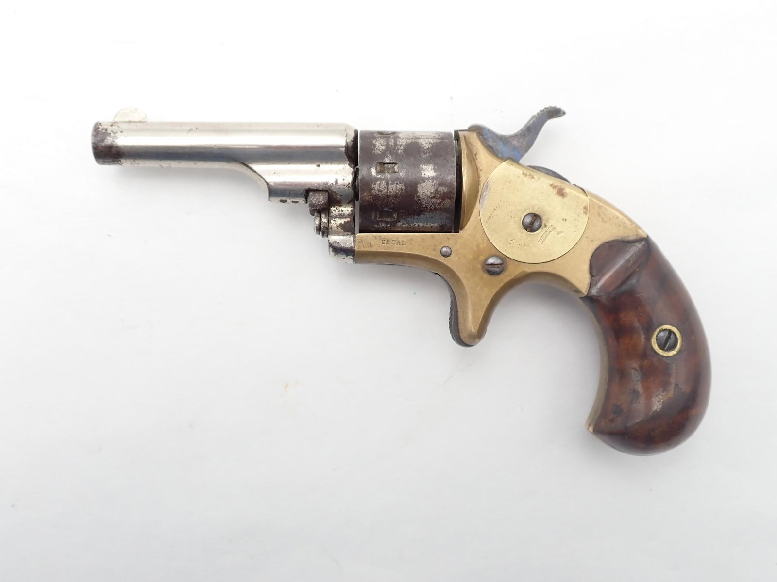 Colt Open Top Pocket Model Revolver: SN: 77285 Cal: .22 Rimfire Action Type: Single Action Barrel Length: 2.25" Sights/Optics: Original Sights Stock: Original wood grips Finish: Nickel finished barrel and cylinder, brass frame Finish